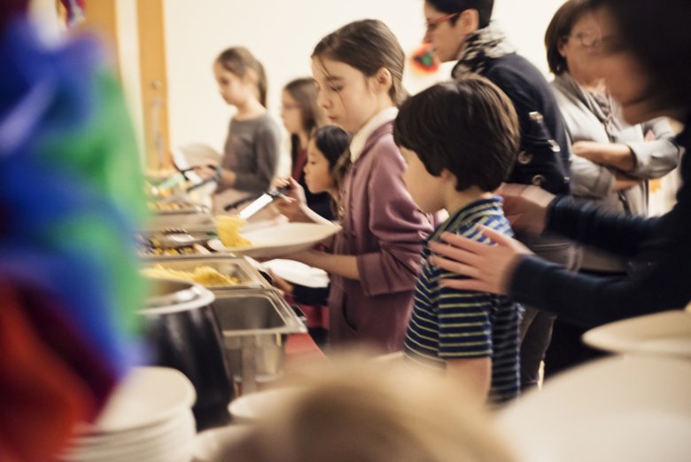 Children standing in line for school lunch