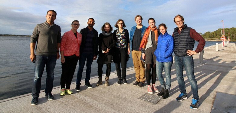 Research group standing in front of the water