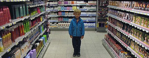 Child in a store surrounded by cosmetics