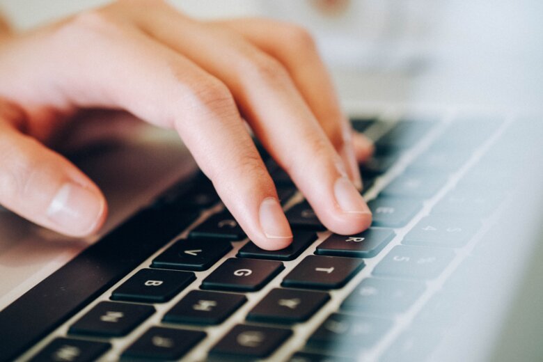 Fingers on a computer keyboard.