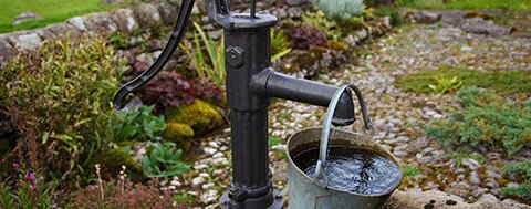 A genre picture with a metal bucket and water pump in metal