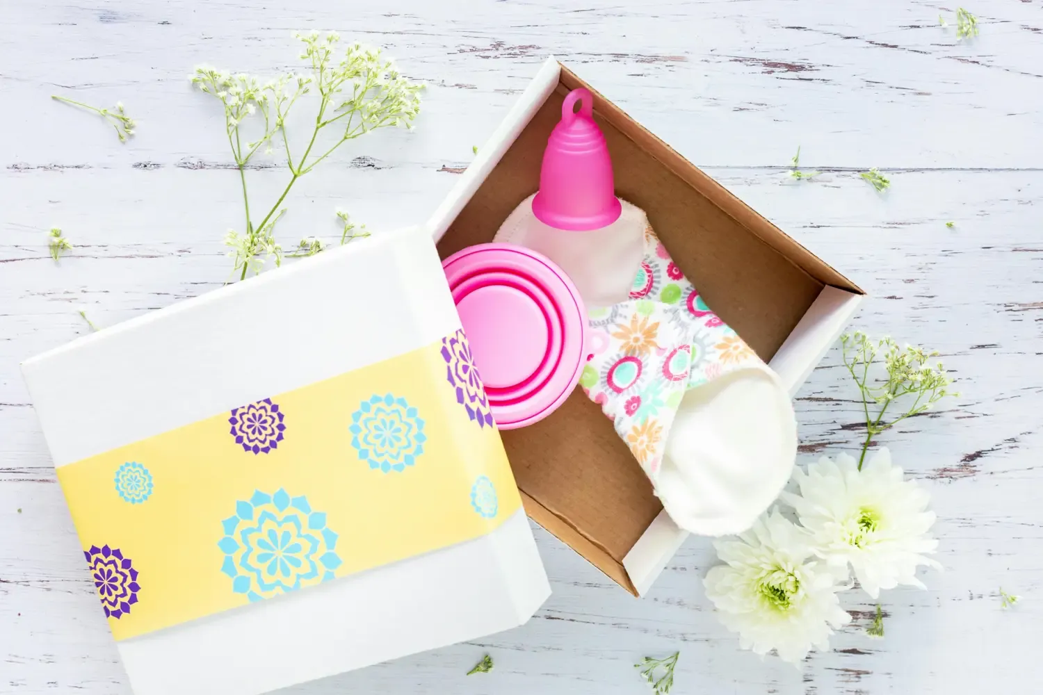 box with a pd and period cup