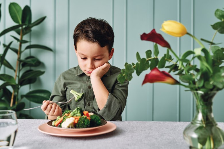 Boy eating vegetables