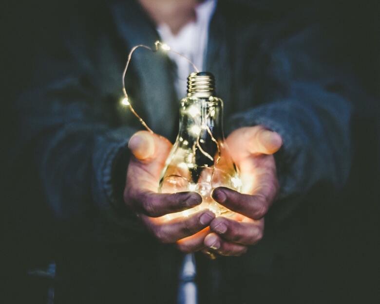 Person holding light bulb in his hands