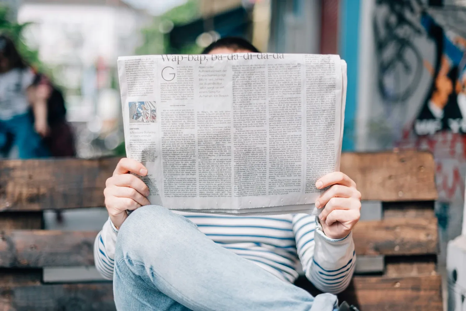 Person reading a newspaper.