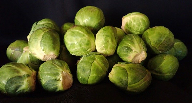 A pile of sprouts against a black background.