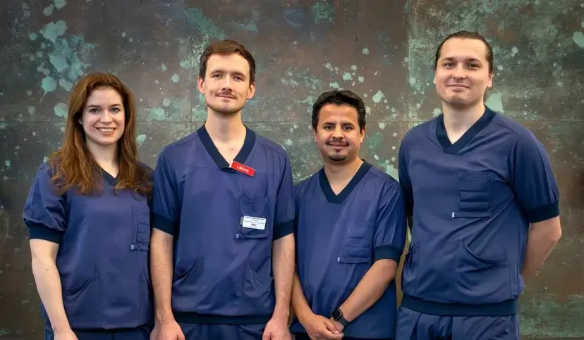 Groupmembers in scrubs lined up for a group photo.