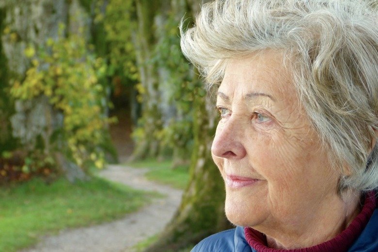 Elderly woman with beautiful nature in the background