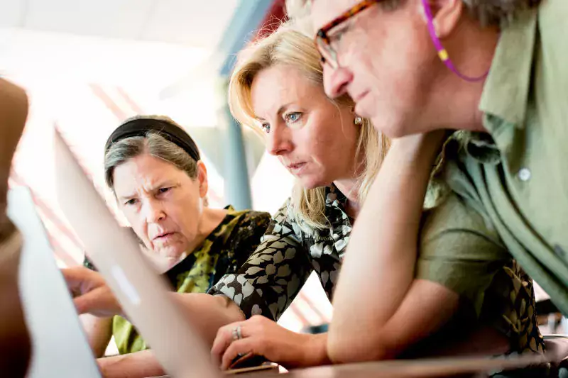 Genre image showing three researchers who seem to analyse results on a computer screen.