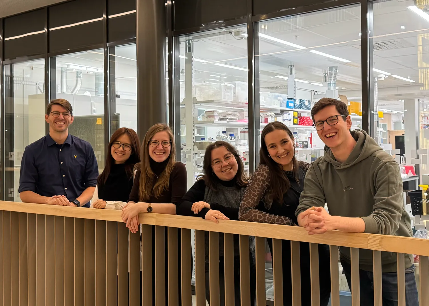 6 people standing smiling for the camera.
