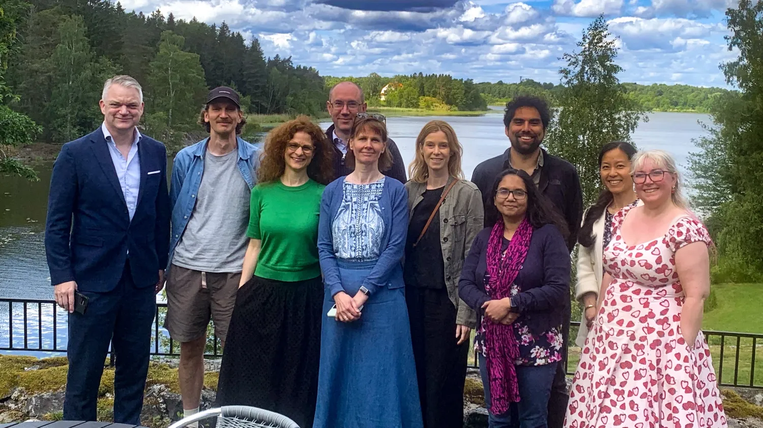 Group photo of 10 people in front of lake view.