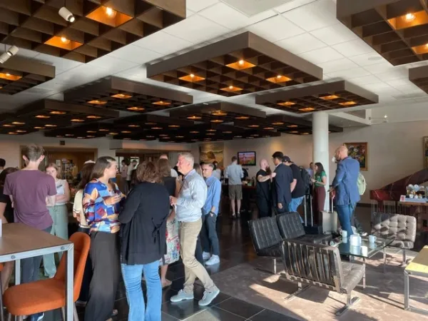 People mingle in a foyer.