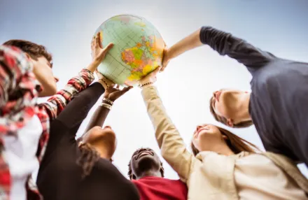 People of diversity holding a globe