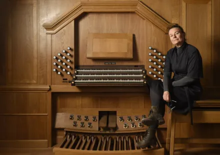 Eva Bojner Horwitz next to a piano.
