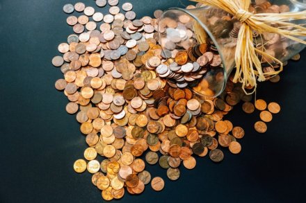 coins pouring out from a glass vase