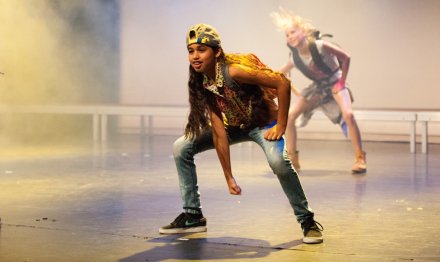 Children dancin on a stage.