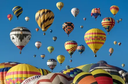 Hot air ballons rising to the sky.