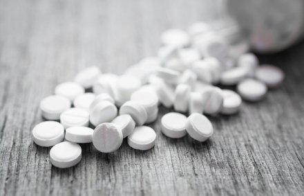 white pills on a wooden table