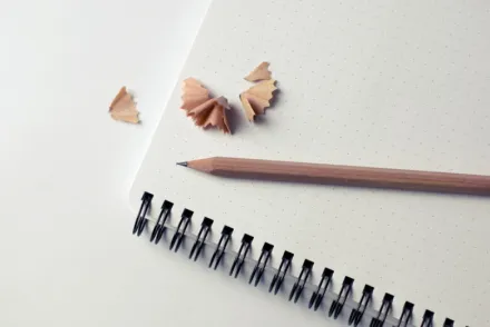 Note pad with a newly sharpened pencil.