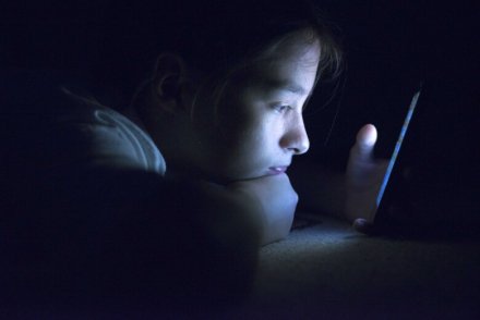 Child looking at mobile.